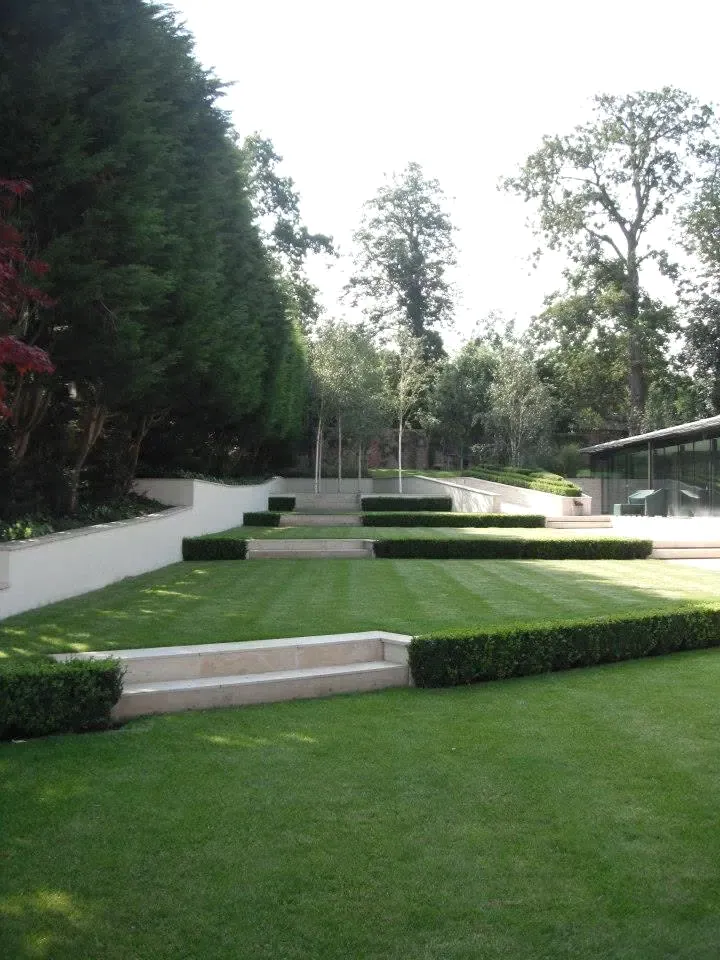 Terraced lawn, clipped hedges and garden steps